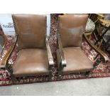 A pair of leather style stud work chairs