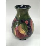 A Walter Moorcroft signed baluster vase decorated