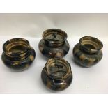 Four unmarked stoneware tobacco jars with steaked glaze decoration