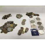 A tin of various foreign coins.