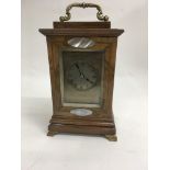 A French walnut case clock inset with mother of pe