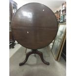 A Georgian mahogany tilt top table on splayed legs