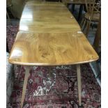An Ercol, light elm drop leaf dining table and con