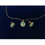 A cased 9ct gold Emerald and diamond pendant and e