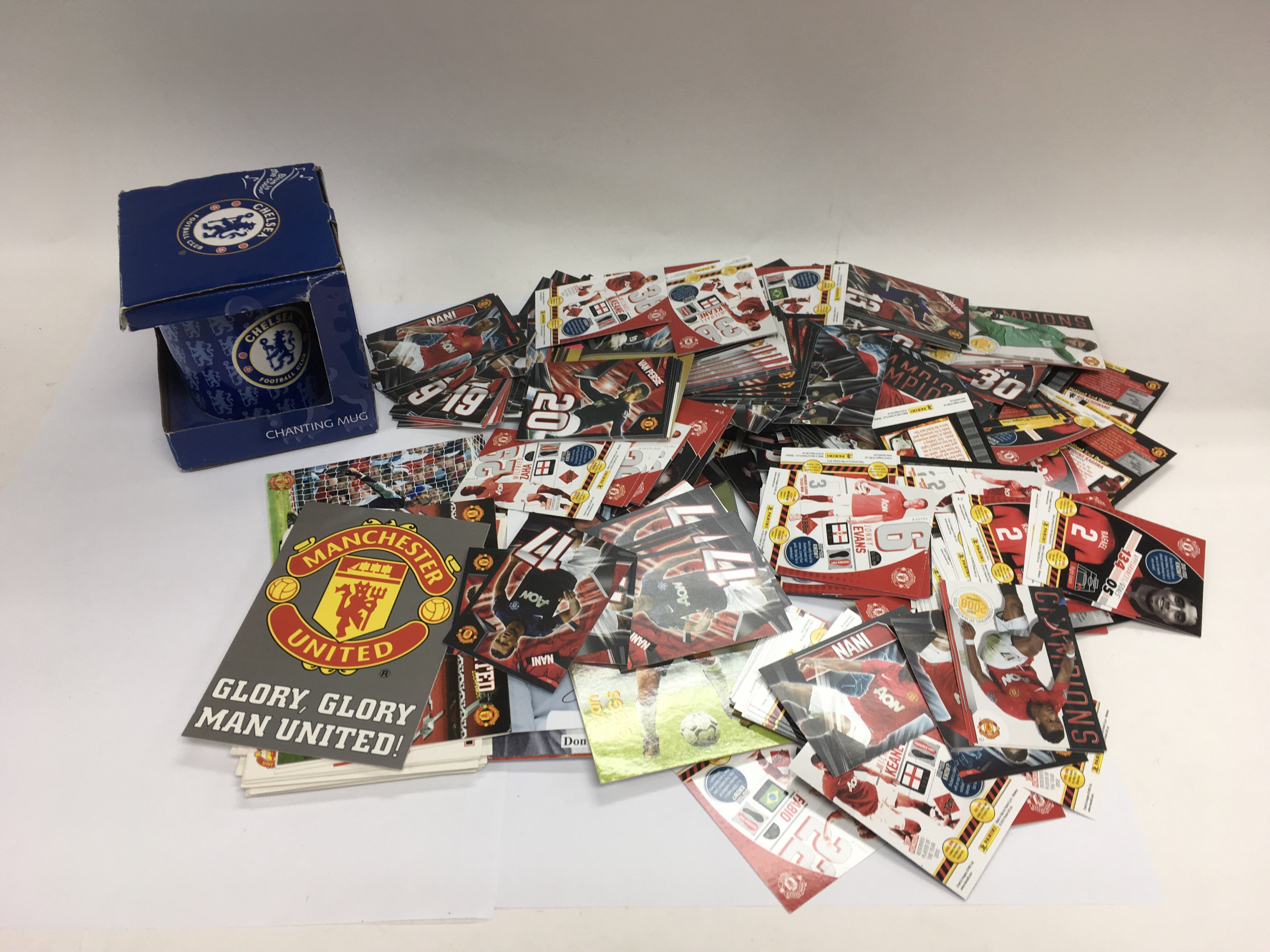 A box containing football memorabilia including postcards, trade cards and framed pictures plus a