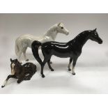 Three Beswick horses comprising a dapple grey, a c