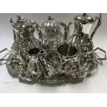 A five piece silver plated tea set comprising tea and coffee pots and a modern tray.