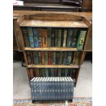 A small open bookcase containing early 20th editions of earlier novels, plus a bookshelf