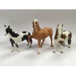 Three Beswick horses comprising a Palomino, a Pint