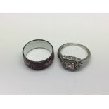 A 9ct white gold ring set with acentral pink stone