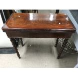 A mahogany and crossbanded card table on barley tw