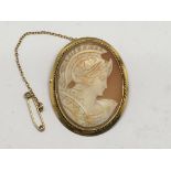 A gold cameo brooch carved with a female warrior