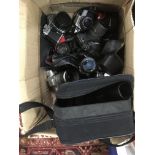 A box of SLR cameras including Nikon and Minolta