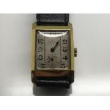 A gold plated wristwatch the square dial with Arab