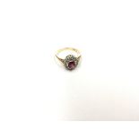 An 18ct Ladies ring set with a central ruby flanke