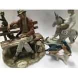 A Capodimonte ceramic figure of a card player on a bench. A Lladro style figure of a boy on a donkey