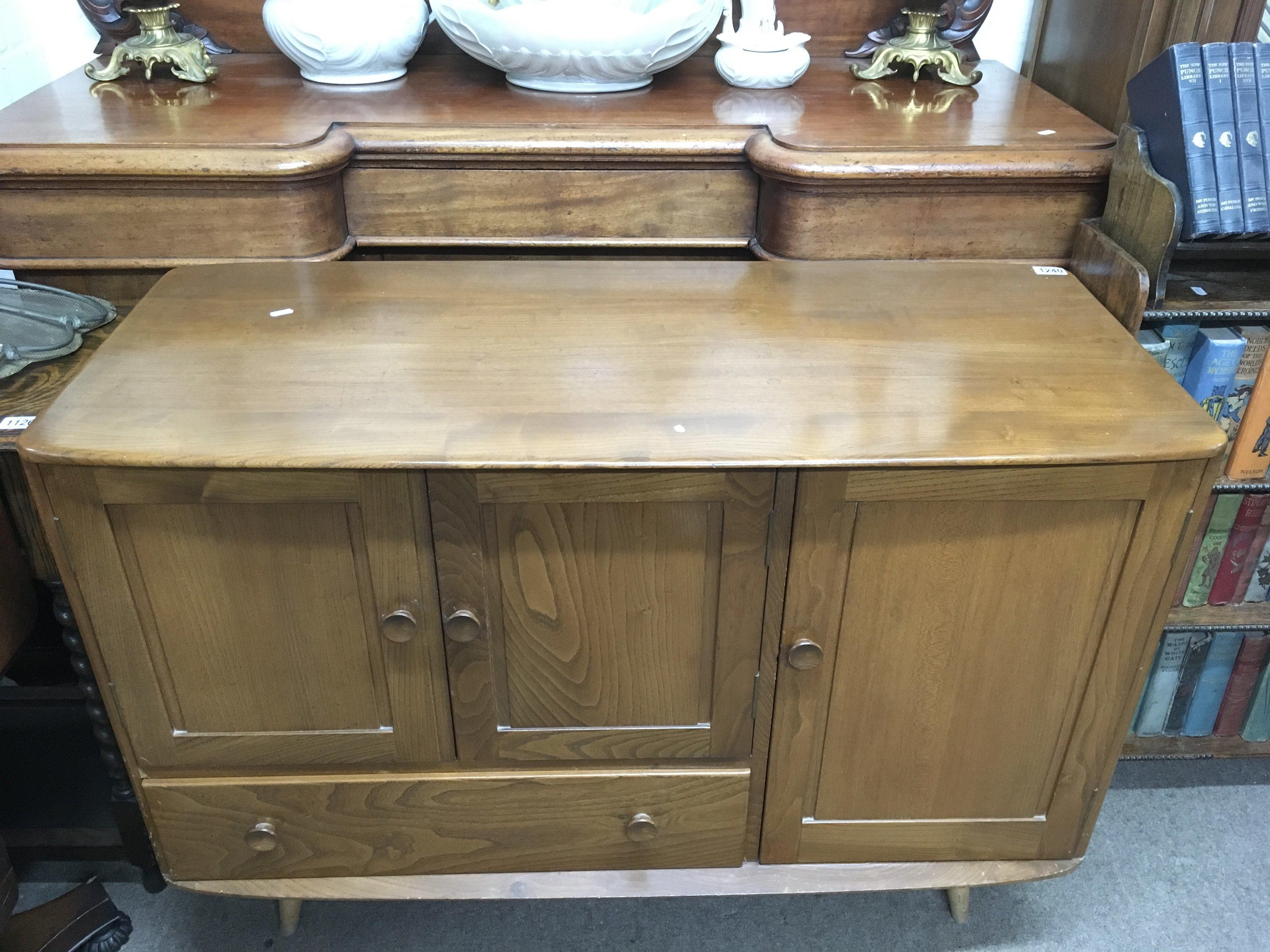 An Ercol mid elm sideboard with cupboards and drawer Approx r50x1.14cmx82cm high