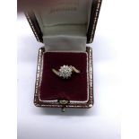 A 9ct gold ring set with small diamond cluster.