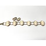 A cameo bracelet together with a pair of earrings.