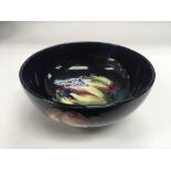 A Moorcroft bowl decorated with flowers and fruit,