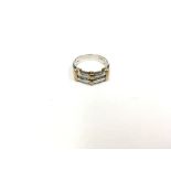 A yellow & white gold 9ct ring set with a row of s