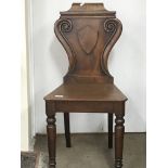 A Victorian mahogany hall chair the solid seat on