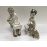 Two Llladro figures of children, one with a dog (2).