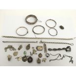 A bag of silver jewellery, charms and medallions
