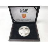 A cased 10oz silver D-Day coin from Jersey.