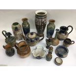 A collection of Doulton and Lambeth wares including a Florrie Jones teapot and pair of vases