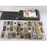 A collection of various loose cigarette cards incl