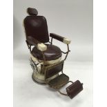 A vintage model of a 1950's style barber's chair,