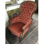 A Victorian button back chair in red upholstery an