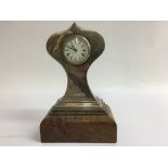 A silver mantel clock the enamel dial with Roman n