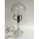 A cut glass table lamp with detached shade