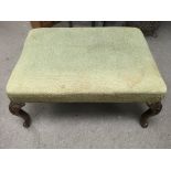 A large Victorian footstool with carved cabriole l