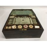 A rosewood sewing box the hinged lid enclosing a f