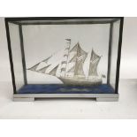 A well detailed silvered miniature two mast sailin