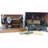 Two old sewing machines with boxes, one by Singer