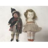 A pair of miniature dolls; one in the figure of a