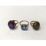 Three 9ct gold rings set with coloured stones. Wei