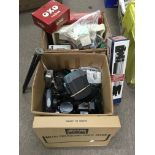 A box containing cameras including a Polaroid and