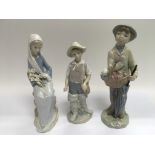 Three Lladro figures of children.