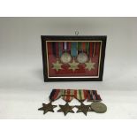 Two groups of Second World War medals, one framed alongside a list of medals included