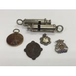 An A.R.P. whistle and one other plus medals and cap badges.