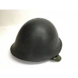 A British Army early "Turtle" helmet. Liner dated 1952.