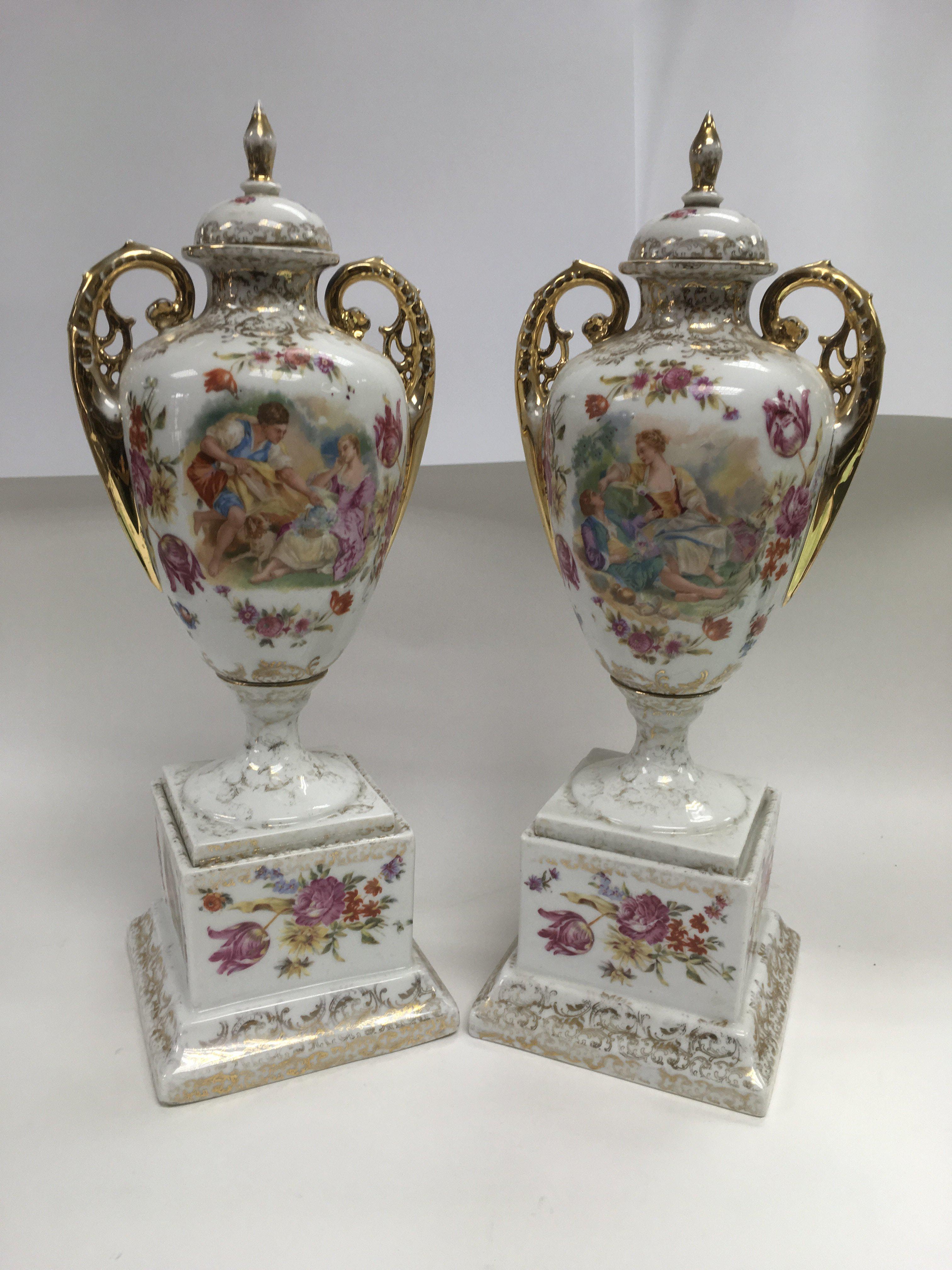 A pair of ceramic lidded vases with transfer print