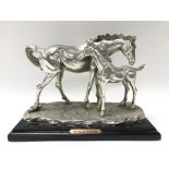 A cast figure of a pair of horses on a black woode