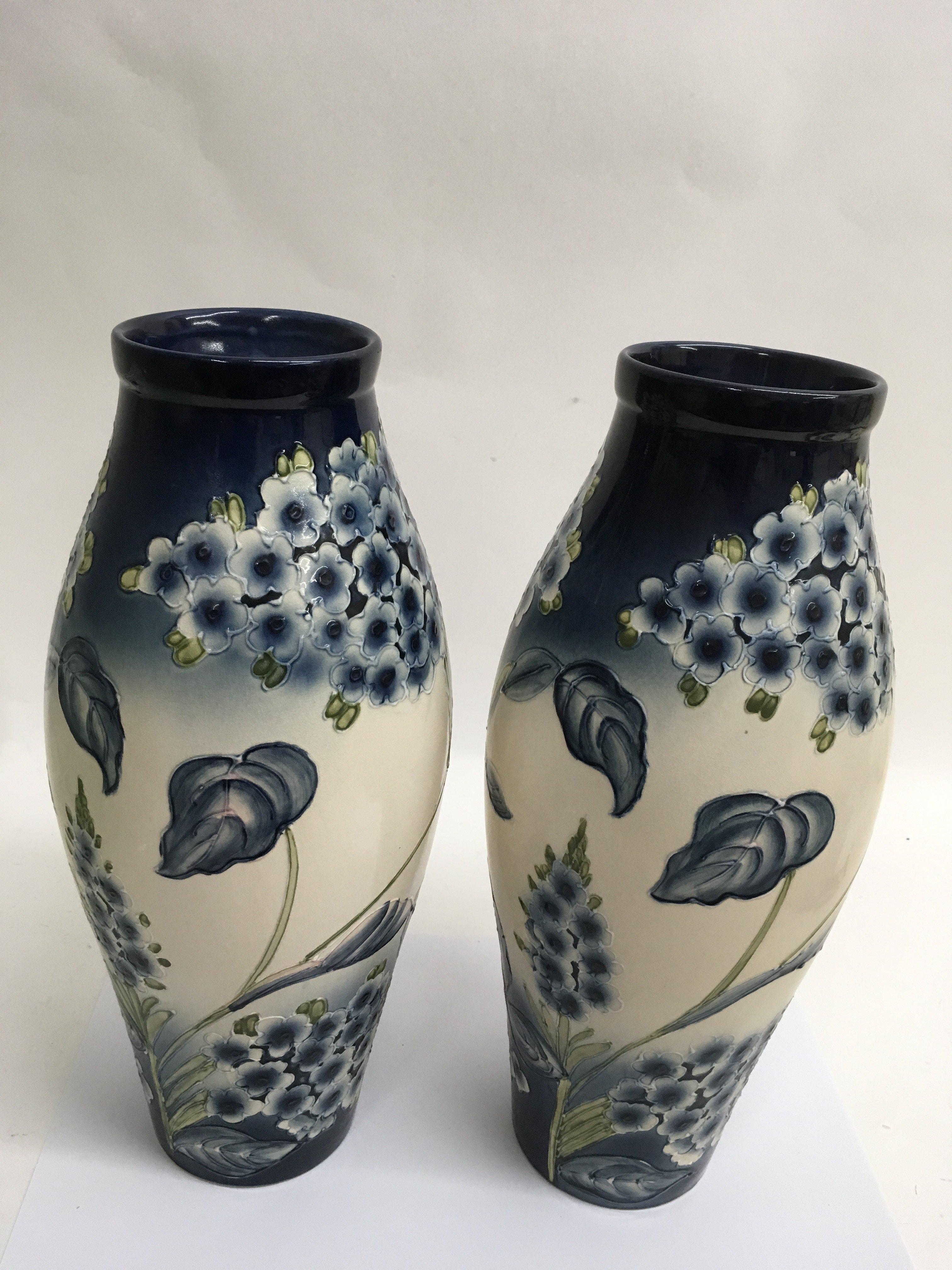 A large and impressive pair of tube lined vases de