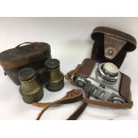 A pair of brass cased binoculars and a Zeiss Ikon